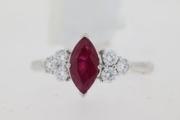 Platinum marquise cut ruby ring with three brilliant cut diamonds set at each side. Approximate ruby