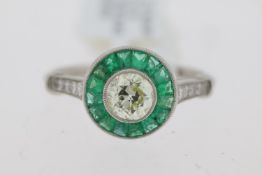 Platinum round old cut centre diamond approx 0.60ct with green emerald cluster and diamond set