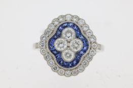 Platinum sapphire and diamond Edwardian style dress ring. 4 central round brilliant cut diamonds