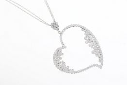 18ct White gold Diamond set heart shaped pendant suspended from diamond set flower cluster on