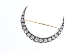 Victorian Crescent Brooch set with old mine cut diamonds. Total carat weight 2.50ct approximately.