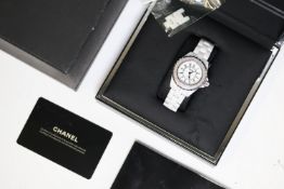 LADIES CHANEL J12 WHITE CERAMIC DIAMOND BEZEL BOX AND PAPERS 2009, circular white dial with arabic