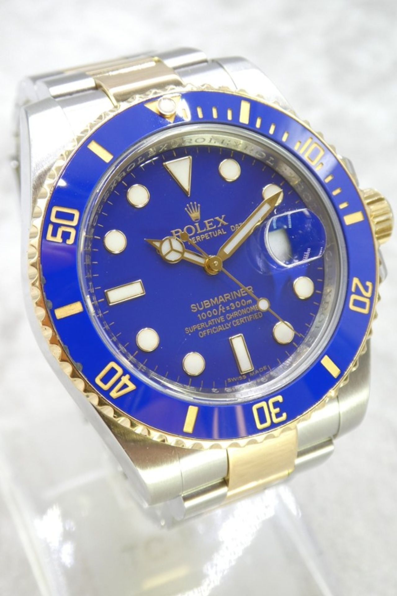 A Bi-Metal Rolex Submariner Watch, Stainless steel and 18ct yellow gold with a blue bezel and a blue