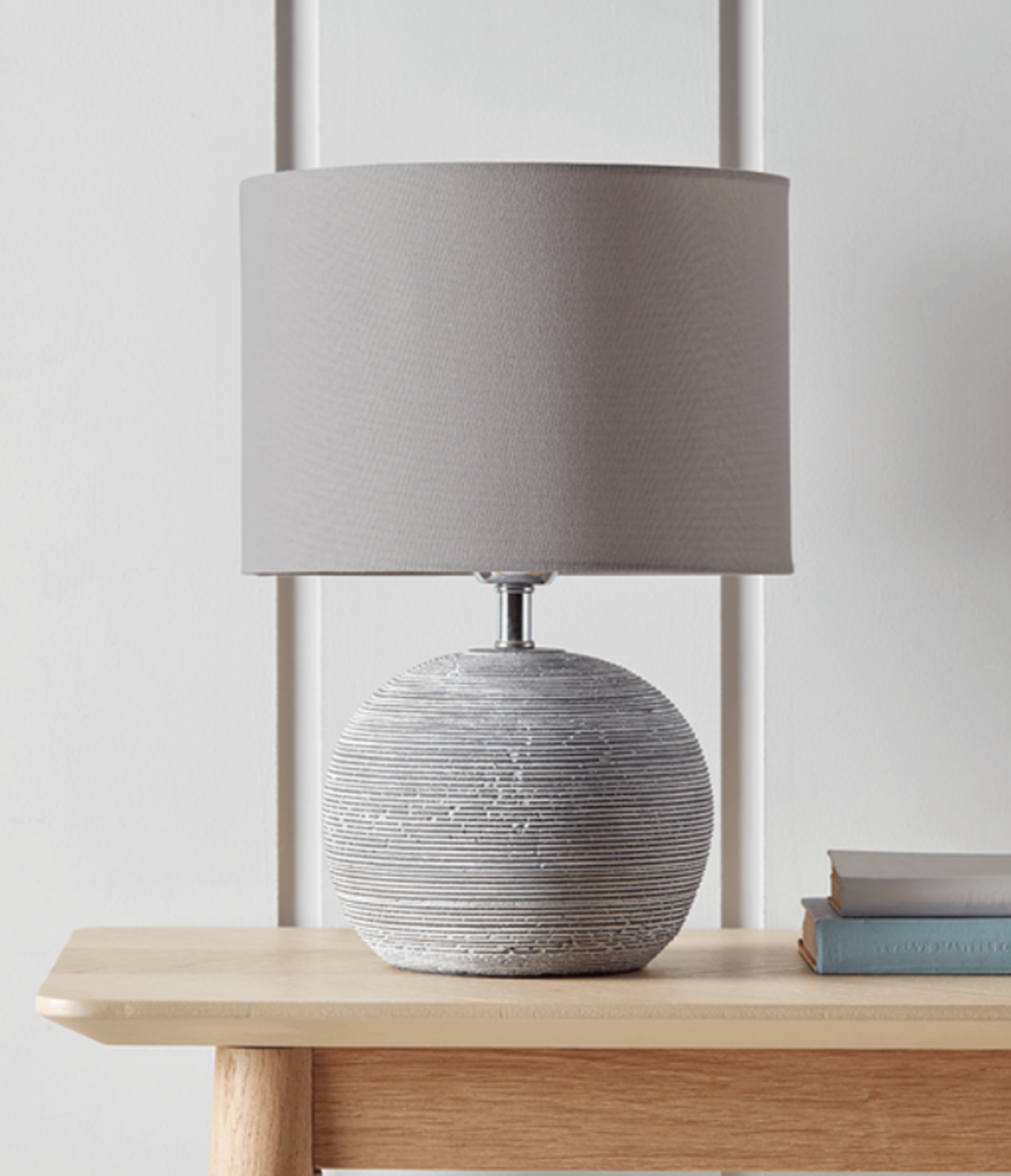 Round Concrete Bedside Lamp. RRP £125.00. Crafted from a grey toned terracotta with a subtle