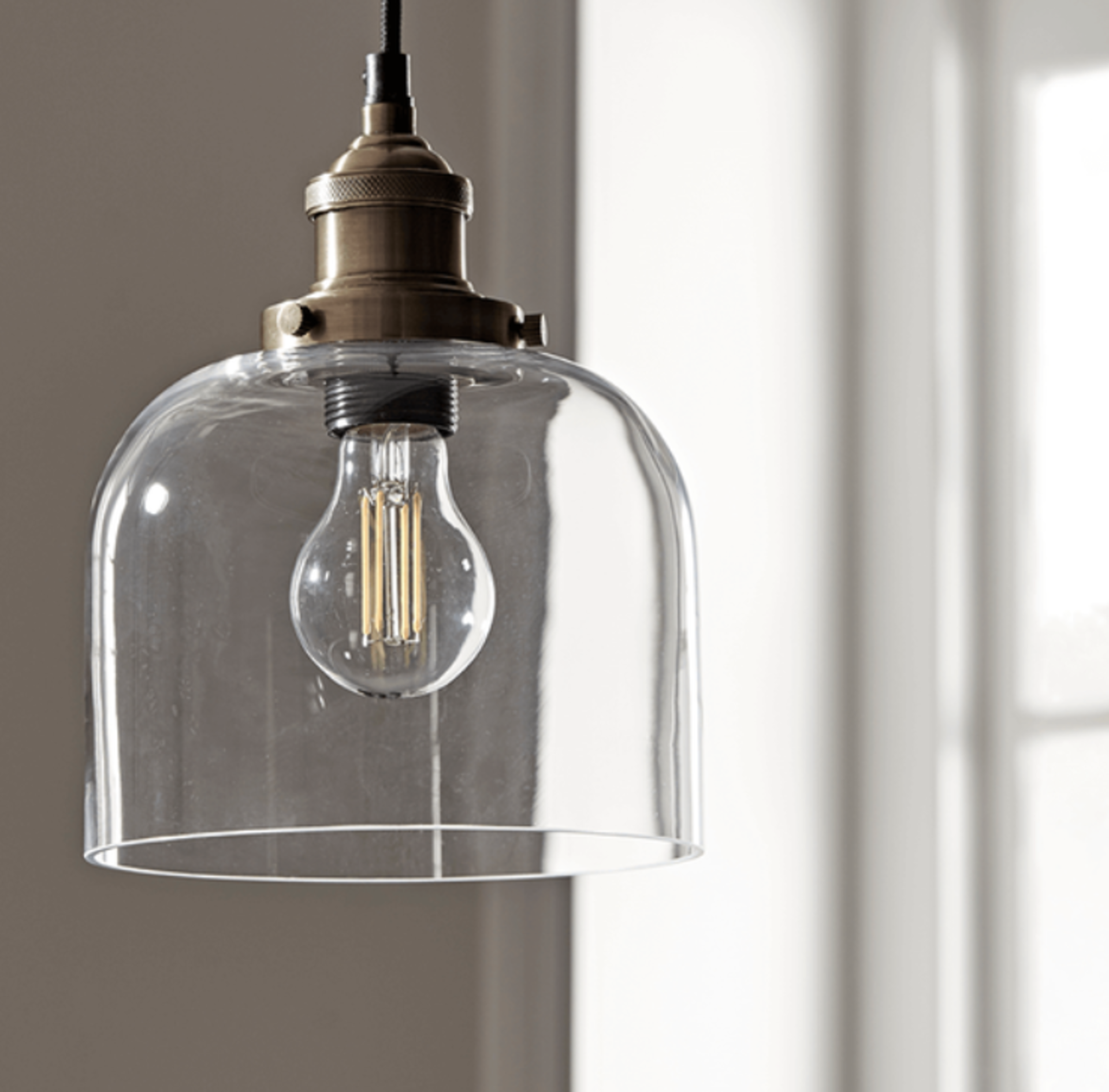 Brass & Glass Pendant. RRP £185.00. With a clear shade and brass fittings, our glass pendant will