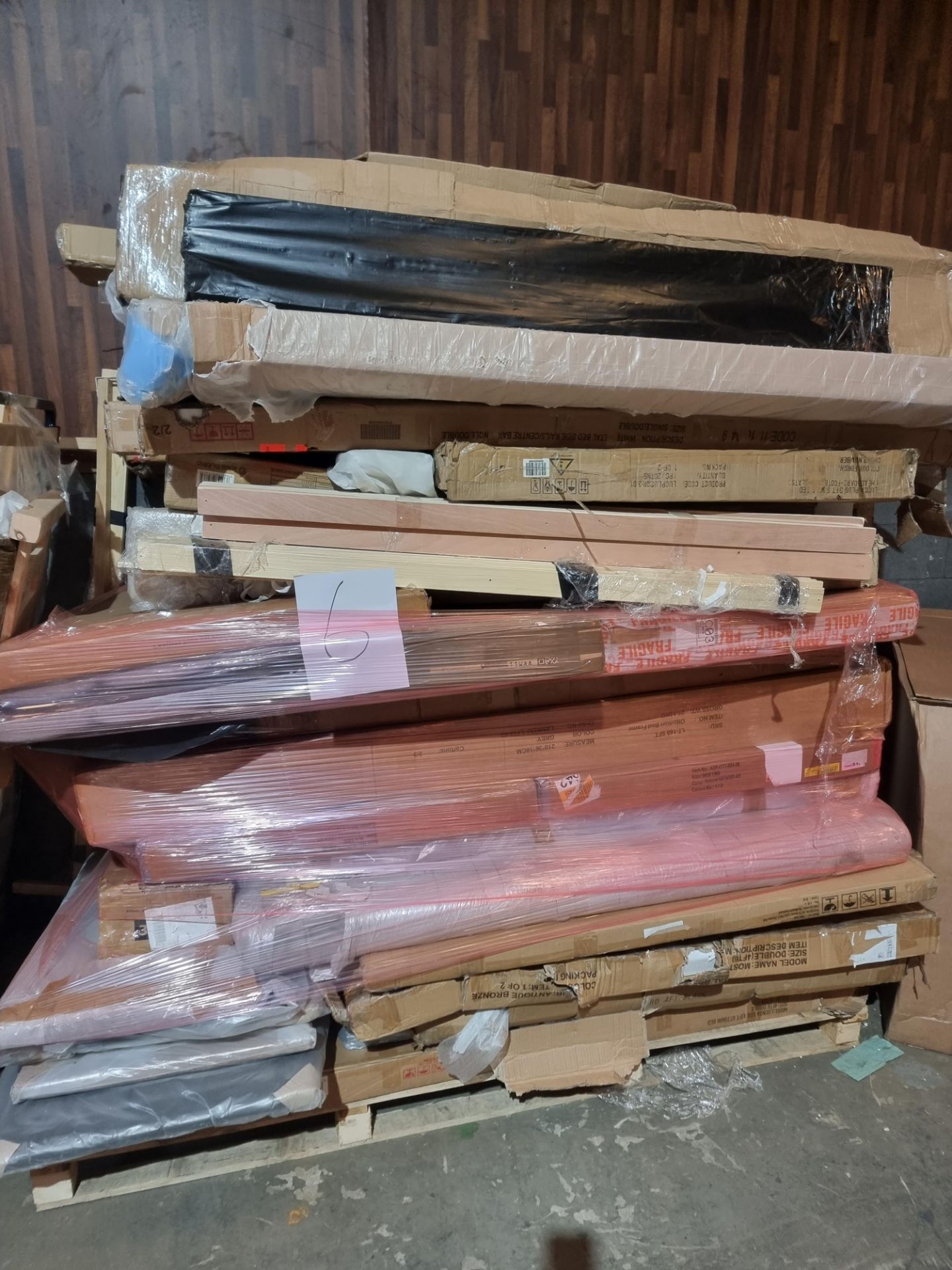 large wayfair pallet containing a large number of different bedframes and headboards