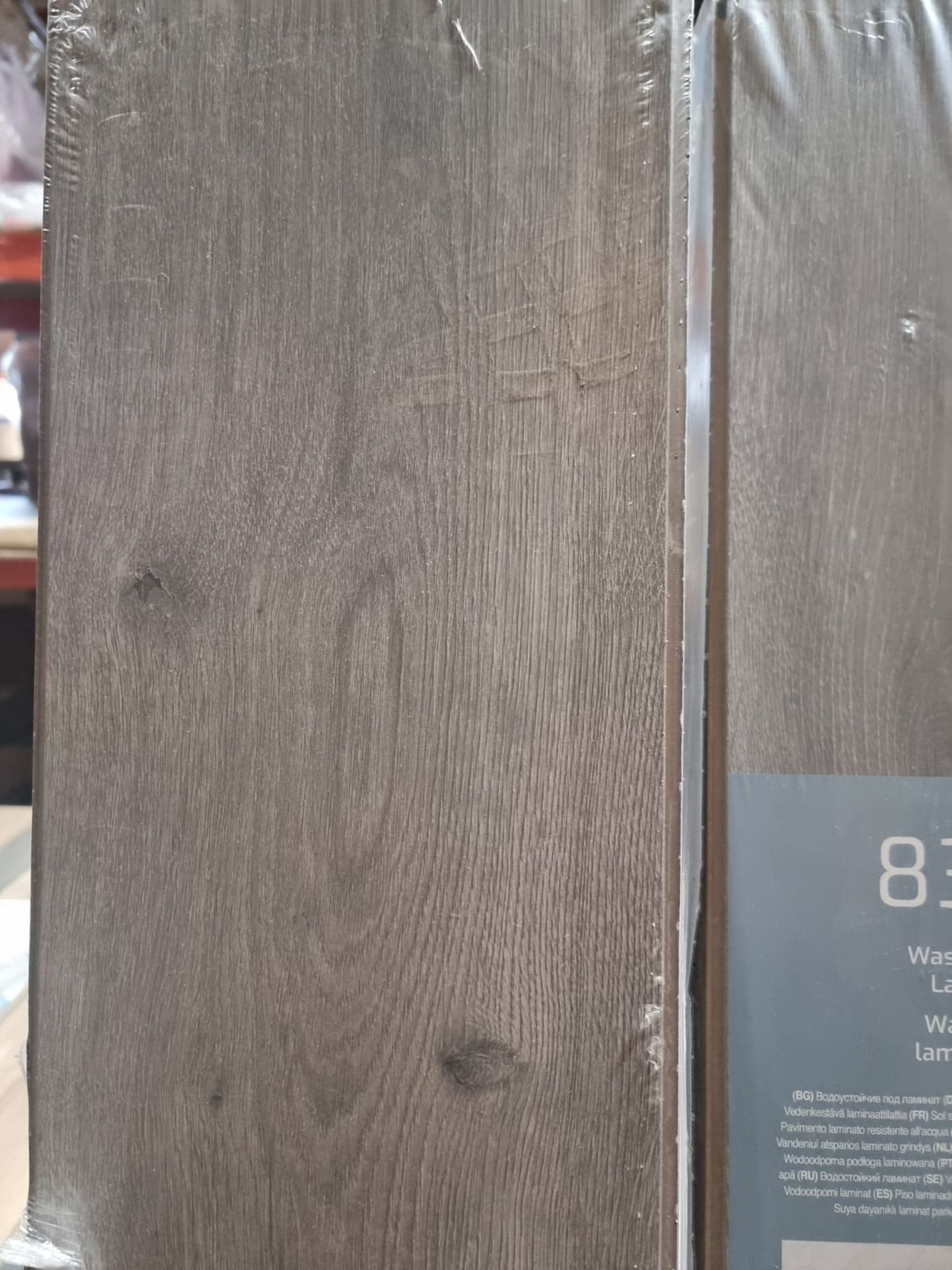 11 x PACKS OF OAK GREY BROWN AMINATE FLOORING. MADE IN GERMANY. 8MM THICK. EACH PACK CONTAINS 1.