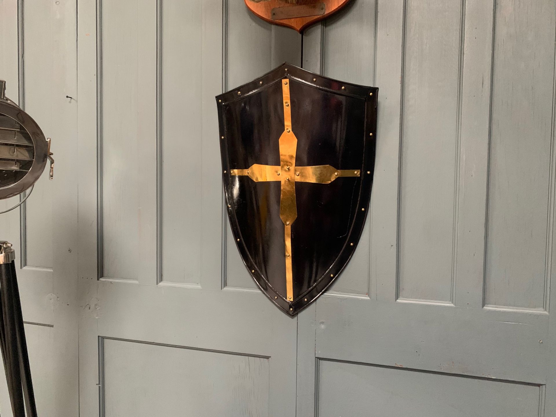 LARGE BLACK AND BRASS ROMAN SHIELD