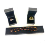 Selection of amber jewellery includes Necklace, Silver and amber ring and a insect insert ring