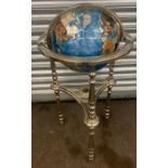 A large gemstone floor standing rotating globe with compass inset measures approx 38 inches tall
