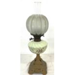 Victorian oil lamp on cast base measures 25 inches tall