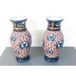 A pair of hand painted oriental vases marks to base measures approx 14 inches high