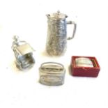 Selection of silver plated items to include 2 Leicester money saving boxes, lidded jug and ricksaw