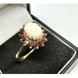9ct gold opal & garnet ring opal measures approx 11mm by 8mm weight 3.9g