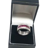 18ct white gold ruby and diamond band ring set with a row of rubies with diamond halo weight 8.7g