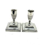 pair of silver candlesticks measure approx height 10cm weighted bases London silver hallmarks