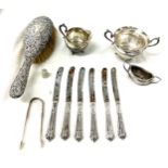Selection of silver items includes silver handled knives, brush etc