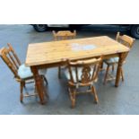 Pine table and four chairs- some water marks and stains to top. Measures approx 59 inches long and