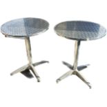 Pair of outdoor stainless garden tables measures approx 28 inches high and 23.5 diameter