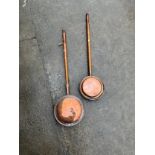 Two copper warming bed pans