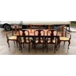 Burwalnut extending Queen Anne table and 8 chairs with ball and clawl feet. -measures approx 81