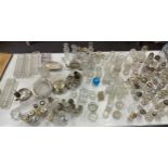 Large selection of silver topped glass jars includes salt and pepper shakers etc