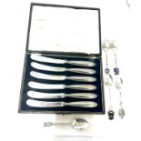 Set of six silver butter knives in original box and a selection of silver spoons