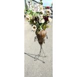 Wrought iron planter together with artificial flowers, height to top of basket 40 inches