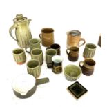 Large selection of assorted studio pottery includes jugs, cups, vase etc