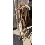 Selection of vintage walking sticks includes umbrellas etc