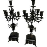 Pair of ornate metal chandeliers on slate bases