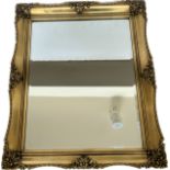 Gilt framed mirror measures approximately 23.5 inches tall 19 inches wide