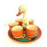 Clarice Cliff pottery egg cups and a chick tray, the chick has been damaged, re-glued