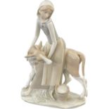 Lladro Porcelain Farmer Girl Miling Cow measures approximately 13 inches tall