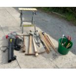 Eckman leaf blower in working order with a selection of large gardening tools and a bench vice