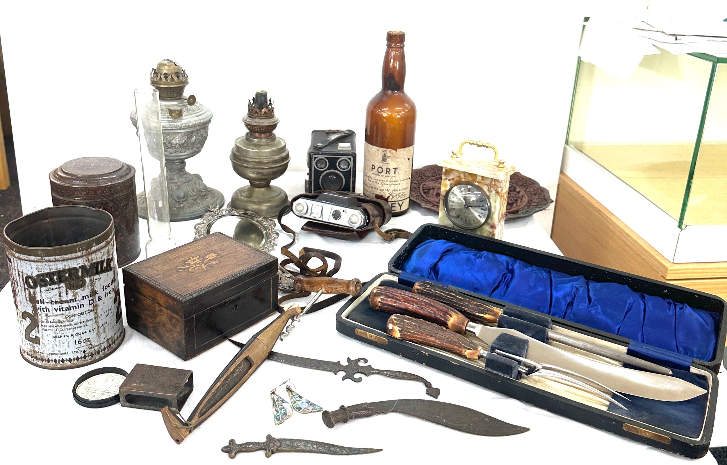 Box of miscellaneous items to include oil lamps, mirror, clock, tea caddy etc