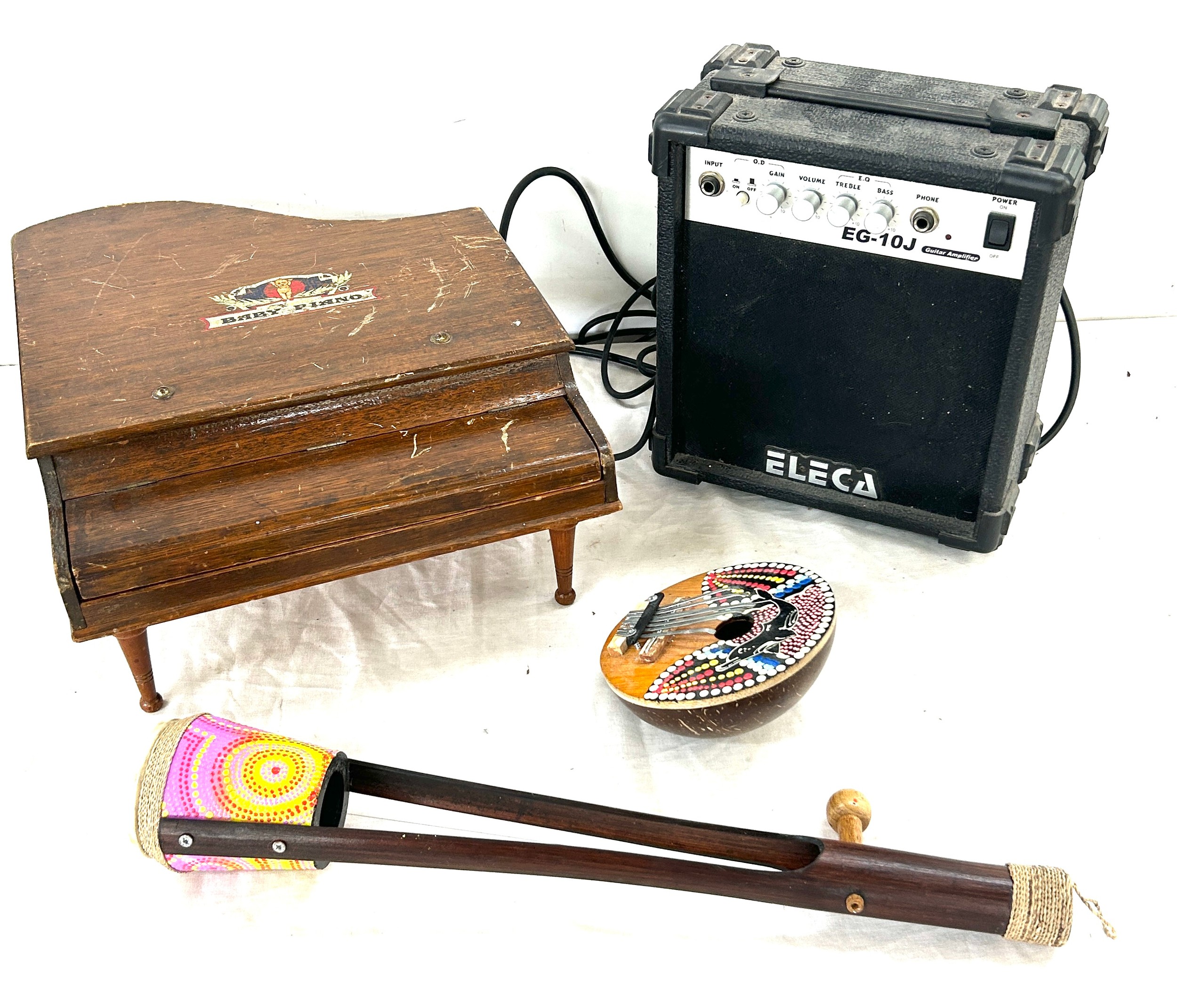 Selection of musical instruments includes baby piano, wooden hand painted instruments, amp etc