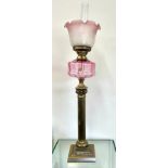 Vintage Cranberry and brass column style oil lamp with shade and funnel, approximate overall