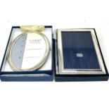 2 boxed silver picture frames largest measures approx 18cm by 13cm