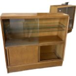 oak mid century oak sliding door book case made by Maple measures approximately 34 inches tall 36