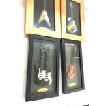 Four framed guitar models two from the Classic guitar collection tallest measures 14 inches