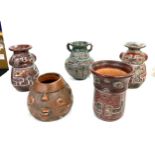 Five South African terracotta vases with stylized figural designs largest measures 19cm tall