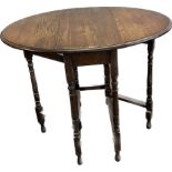 Small oak gate leg occasional table measures approximately 29 inches tall 35 inches wide 24 inches