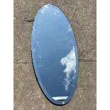 Wall hanging bevelled edge oval frameless mirror measures approximately