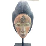 Carved oriental head figure on stand height approximately 46cm