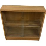 oak mid century oak sliding door book case made by Maple measures approximately 34 inches tall 36