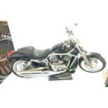 Harley davidson motorbike model on stand, measures approximately 26 inches long
