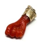Antique gold mounted coral fisted hand pendant