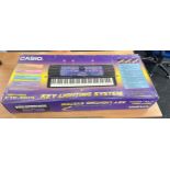 Boxed Casio 100 song bank keyboard, ctk-560l key lighting system and stand
