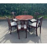 Round mahogany extending table and 6 chairs with pie crust edge, 32 inches tall